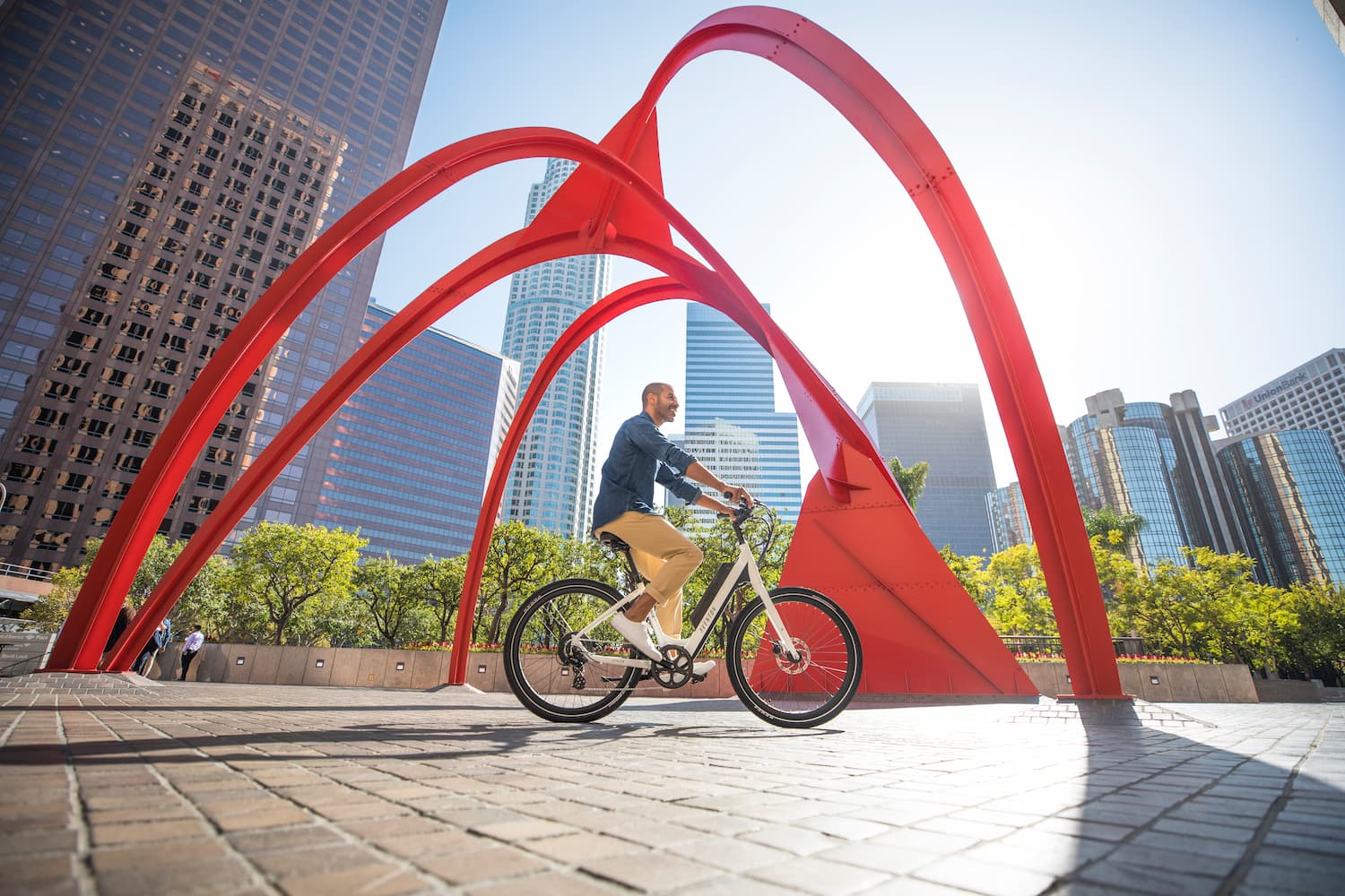 Man rides an Aventon electric bicycle in a city park